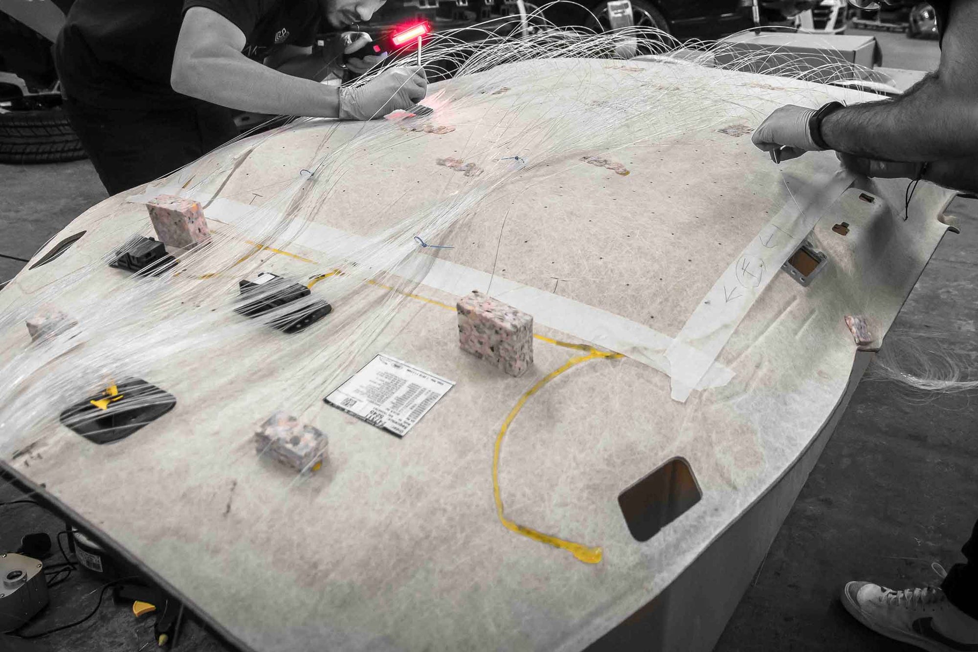 Close-up of the reverse side of a roof lining removed from a Range Rover Sport L494. Fitting fibre optics to create the "starry sky" effect. In Enkahnz workshop 