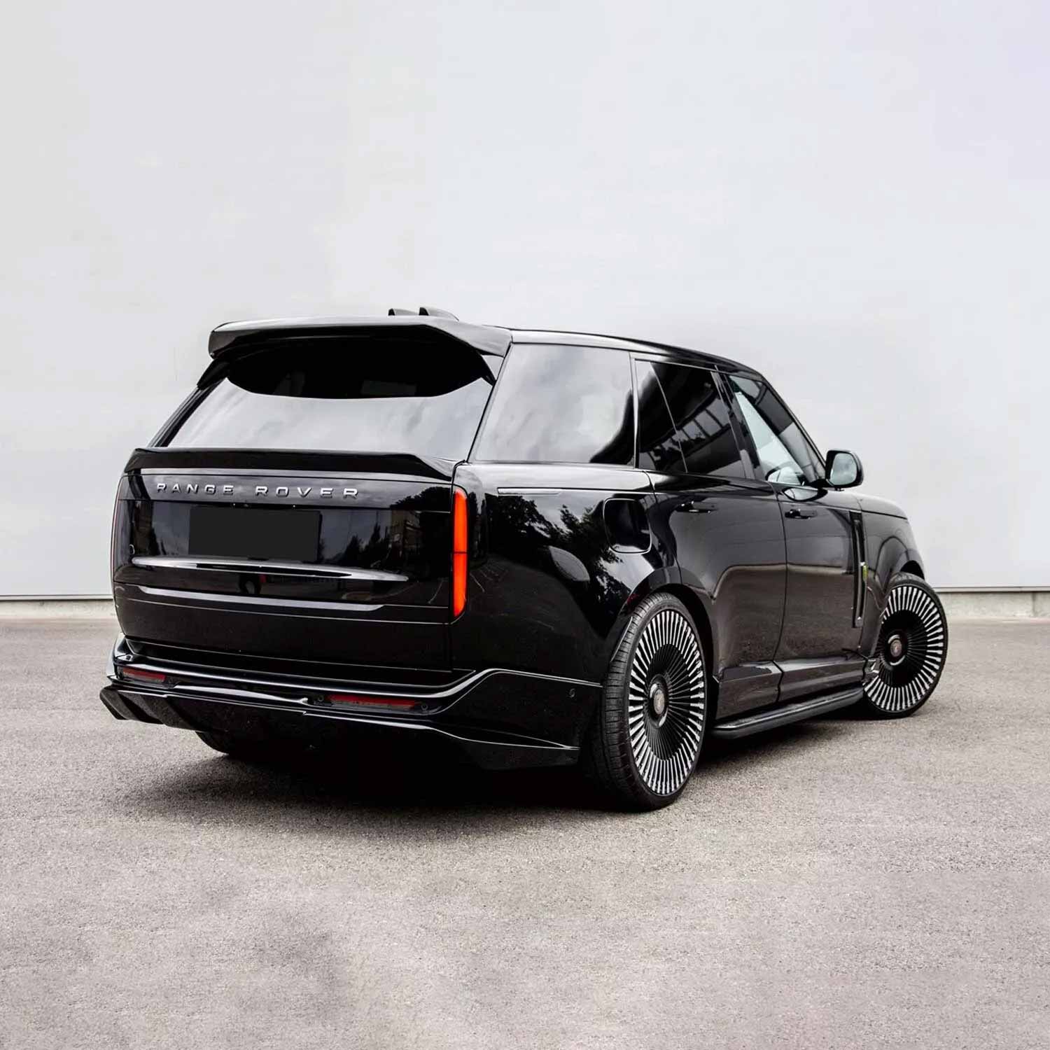 Black Range Rover L460 2022, fitted with Barugzai Nebula bodykit, shown rear quarter angle, parked on a road with a grey background. Fitted with Barugzai Vortex Forged 24" alloy wheels in Gloss Black Polished