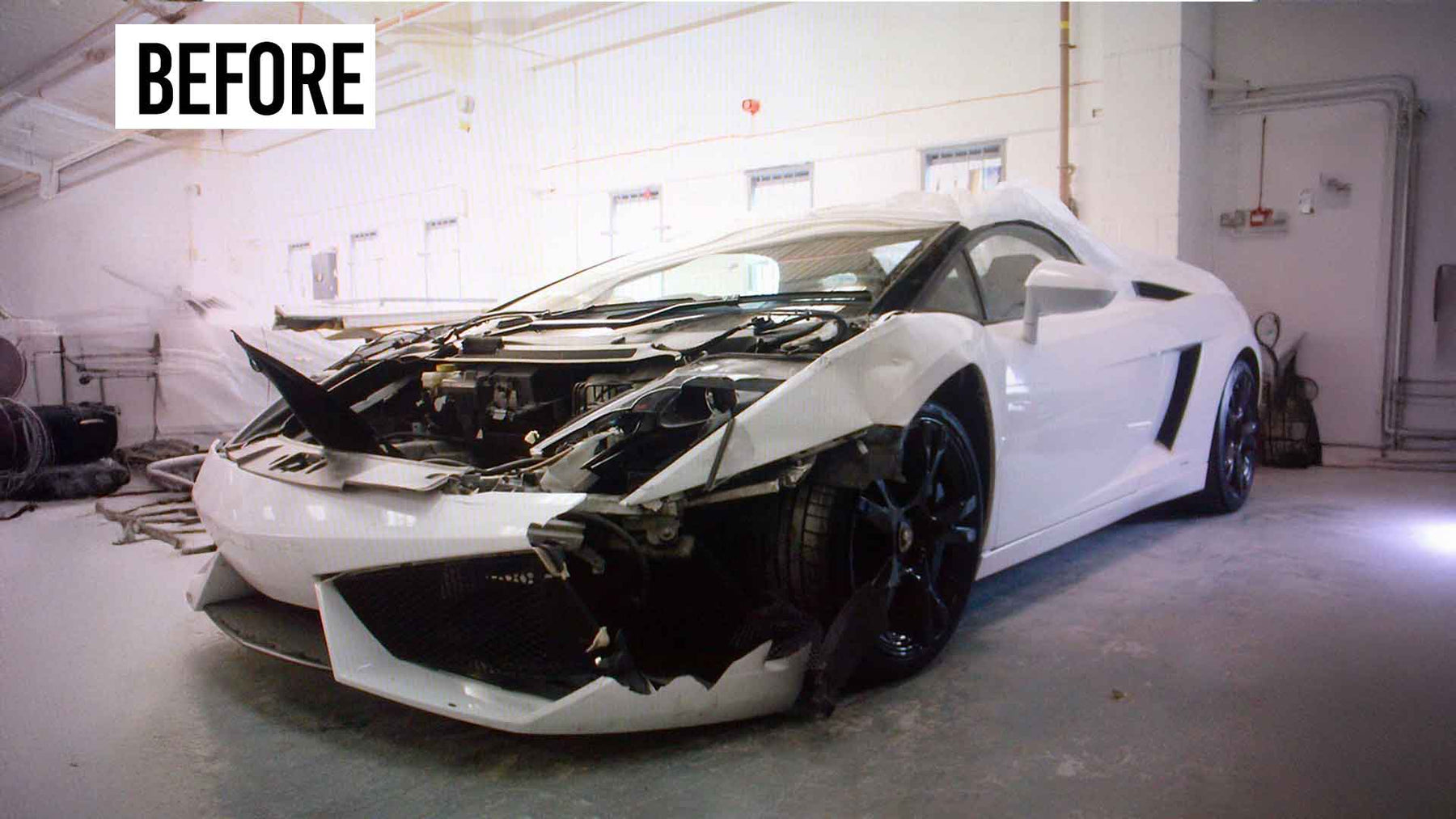 White Lamborghini Gallardo with significant damage in Enkahnz workshop. Before accident repair.