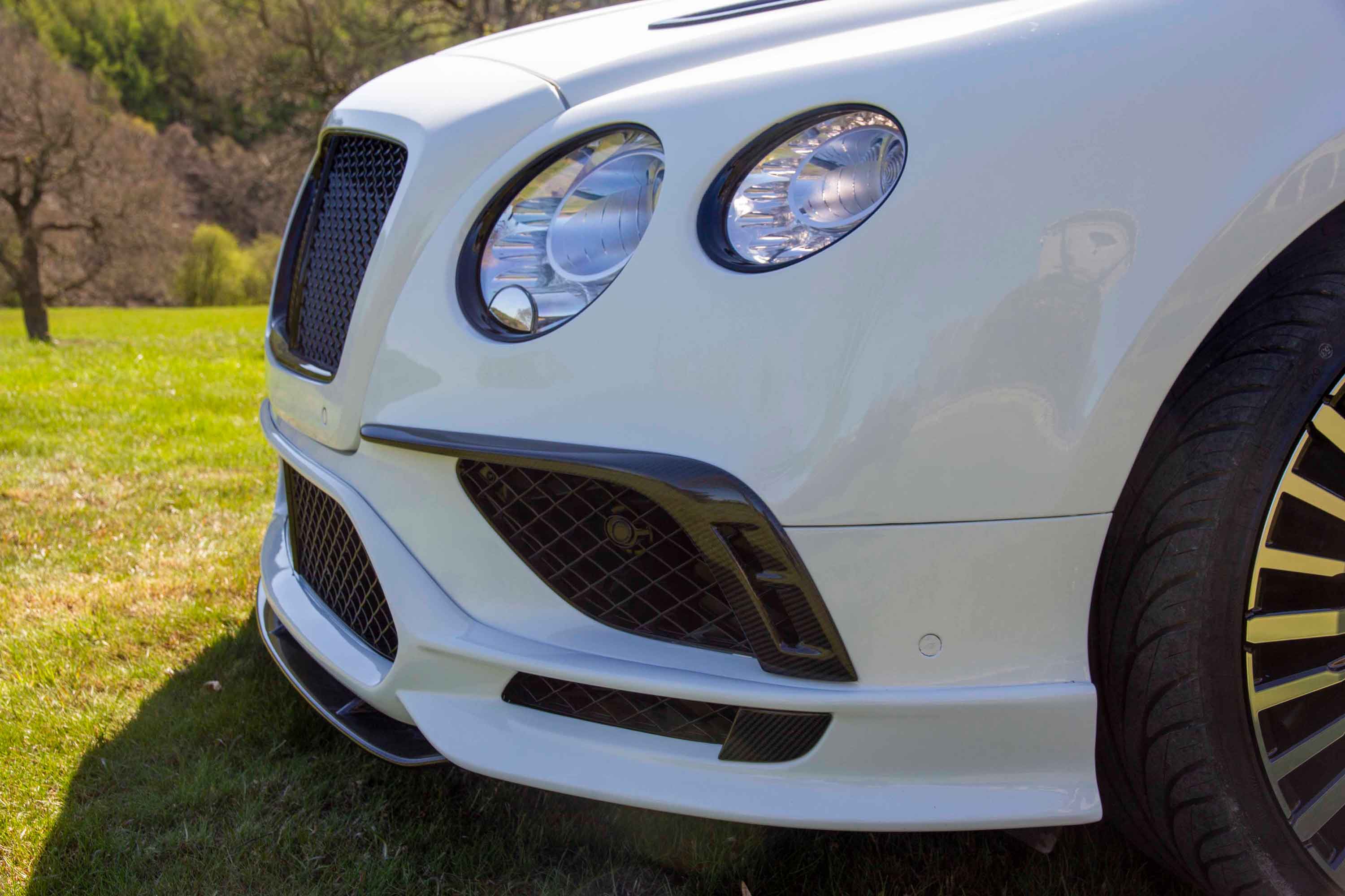 Front close-up of a white Bentley Continental with Barugzai Mayfair II bodykit