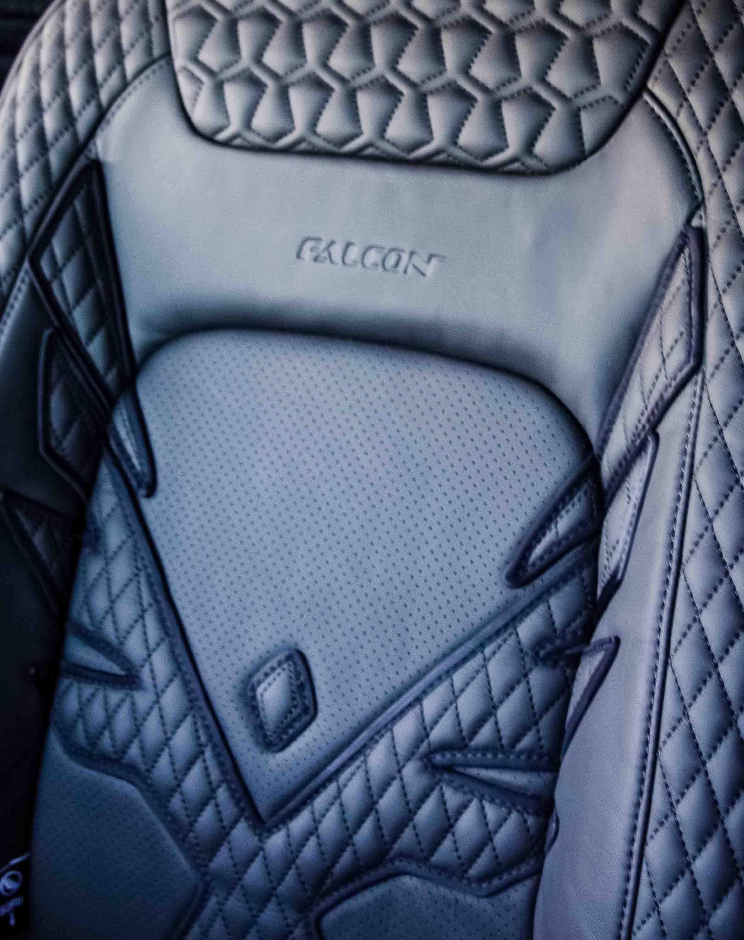 Black quilted car seat with 'Falcon' branding, in a Land Rover Defender 110 L663