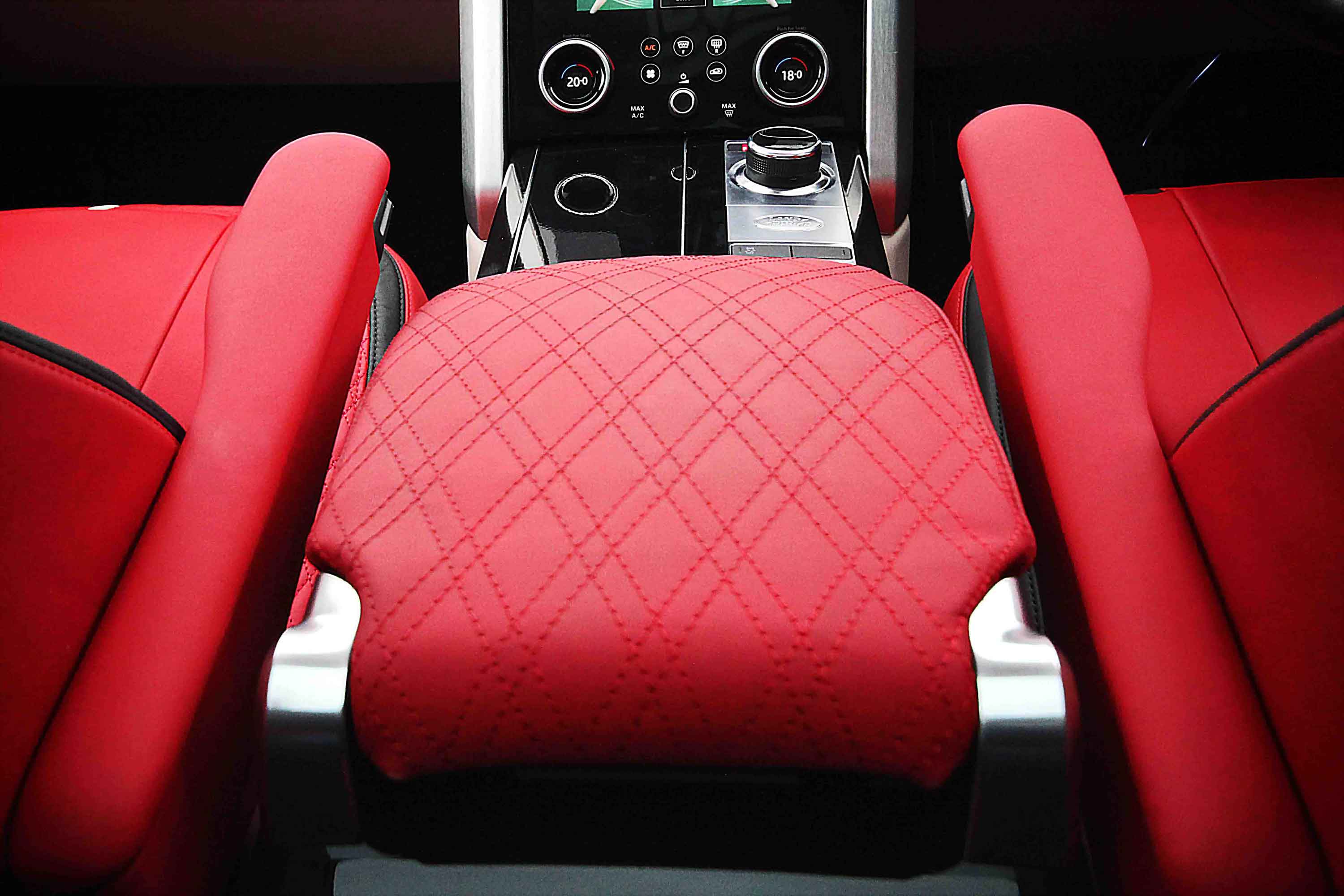 Range Rover L405 interior close-up of red quilted car seat with dashboard in the background