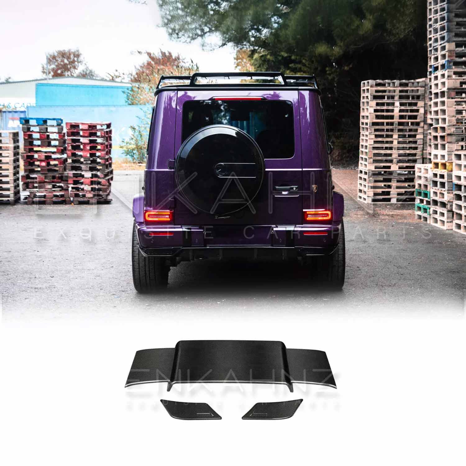 Rear view of Purple Mercedes G Wagon G Class W463A SUV with gloss black wheels fitted with real Carbon Fibre BRBS style Rear Roof Spoiler in front of stacked pallets