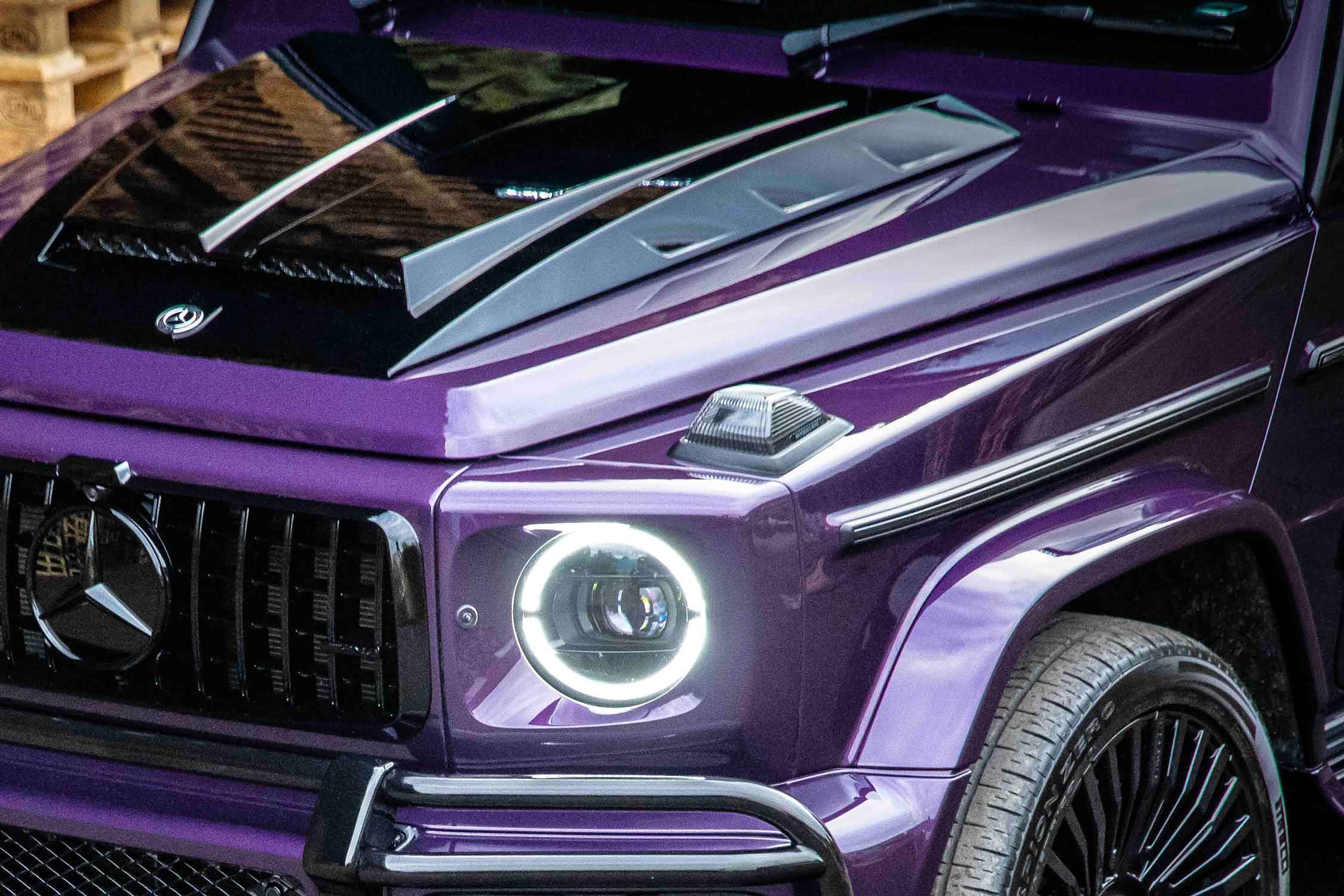 Close-up of a purple Mercedes-Benz G Wagon W463A with a shiny finish and gloss black contrast