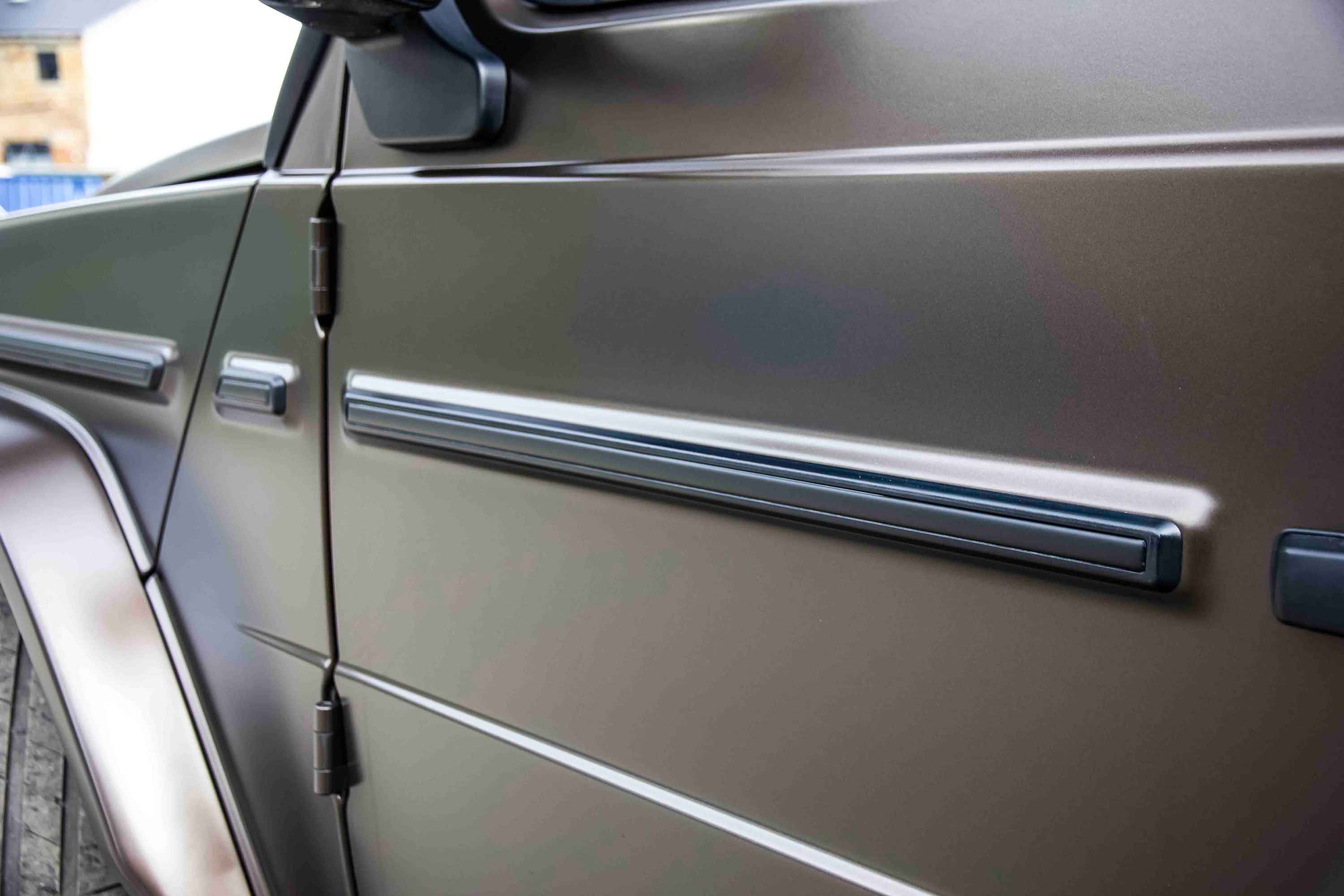 Close-up of a Mercedes-Benz G Wagon W463A car door with a metallic Bronze finish