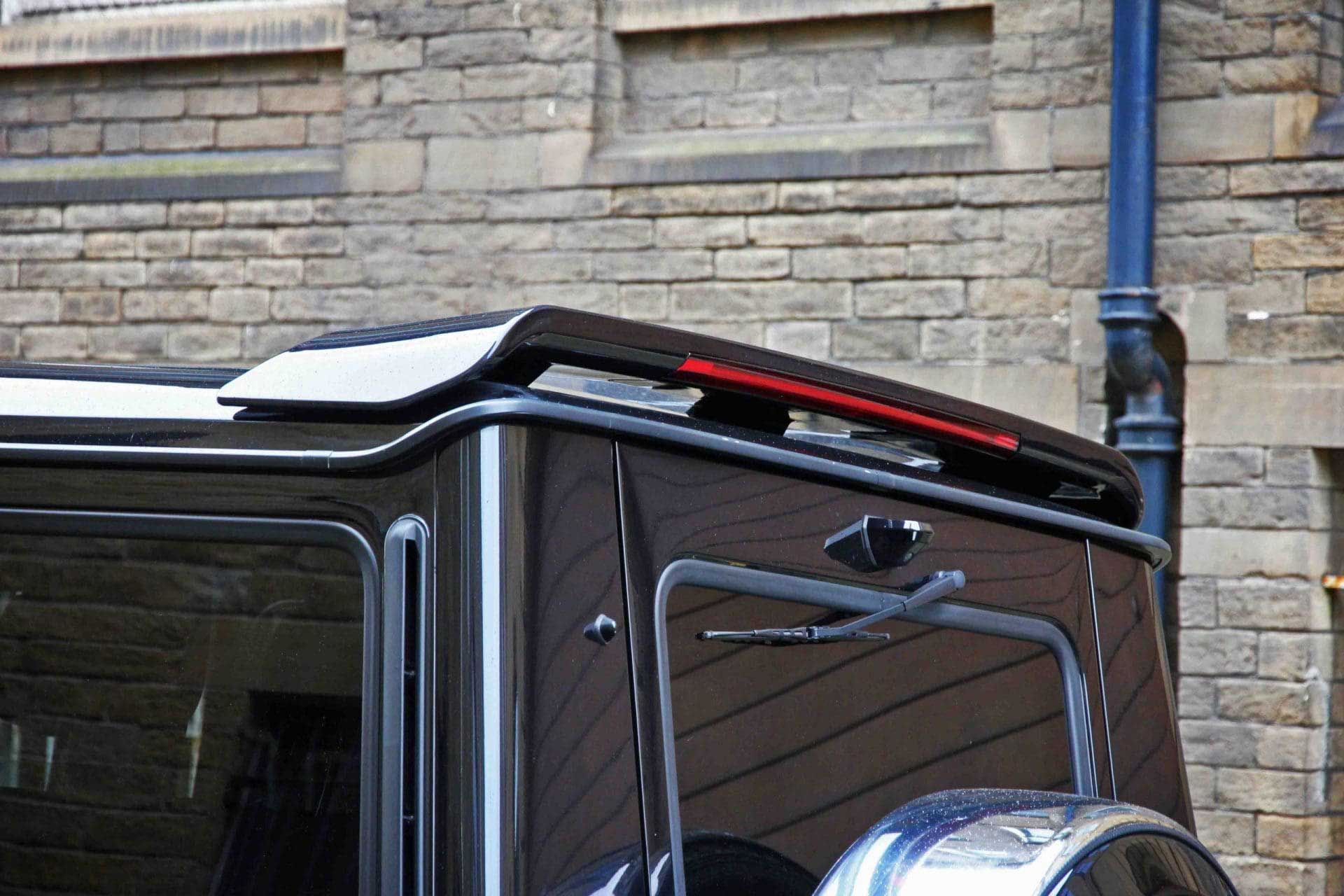 Close-up of a Mercedes G Wagon W463 roof spoiler against a stone wall background
