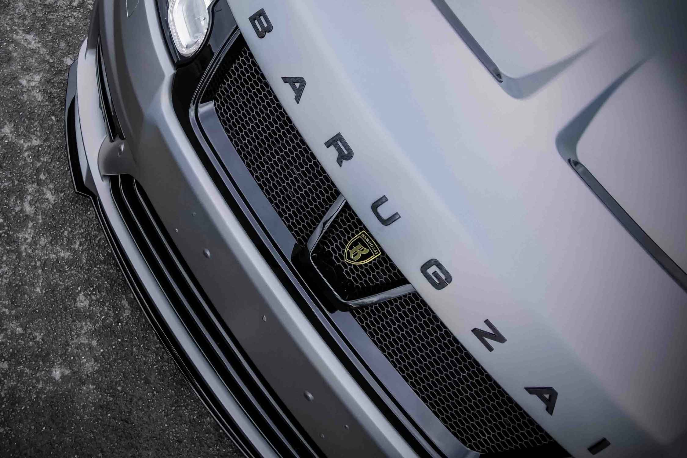 Top view close-up of a Range Rover Sport L494, fitted with Barugzai Sport Aero with branding on a tarmac background. Pearlescent wrap