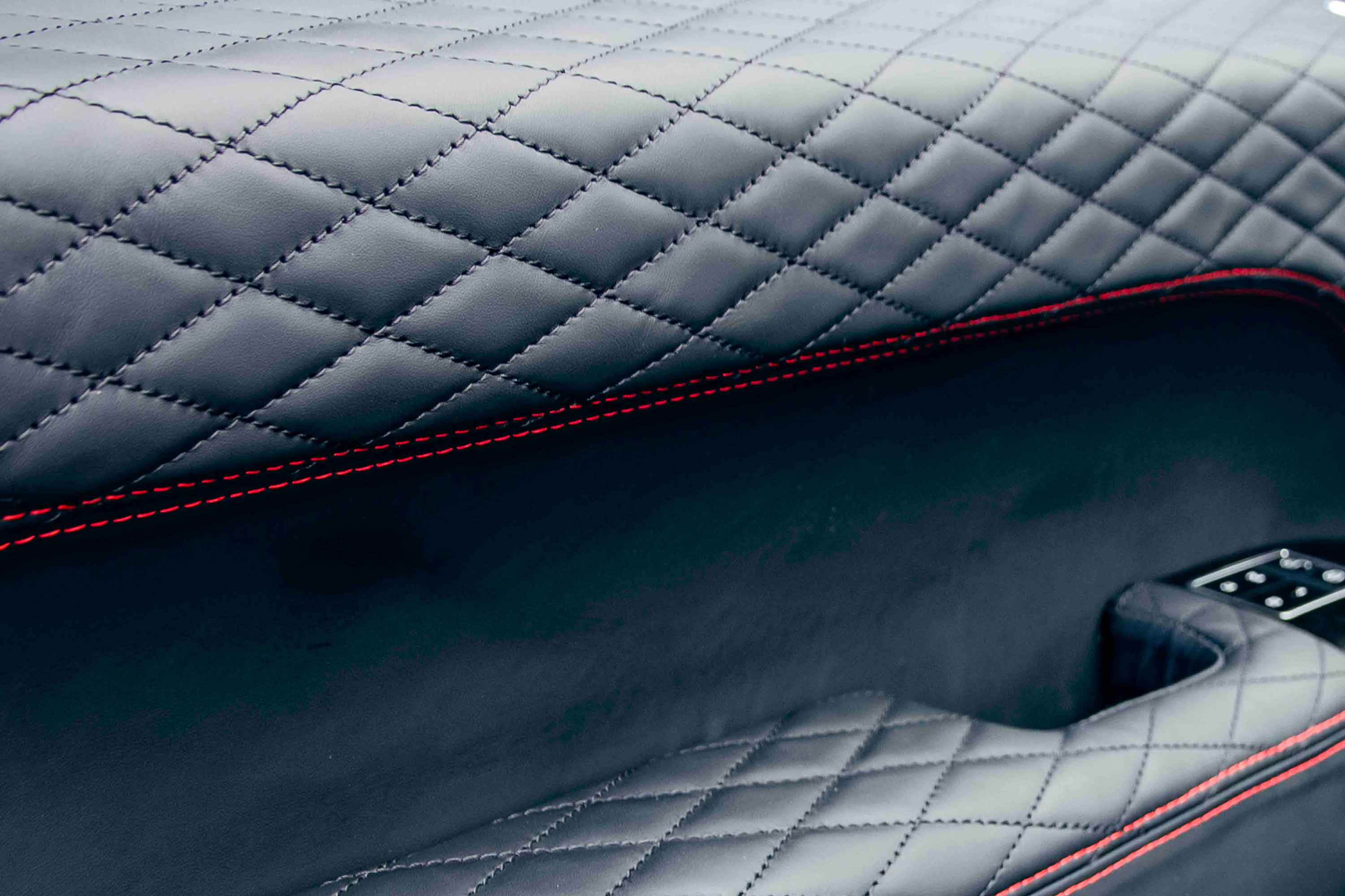 Quilted black leather door card with red stitching detail in a Range Rover L405