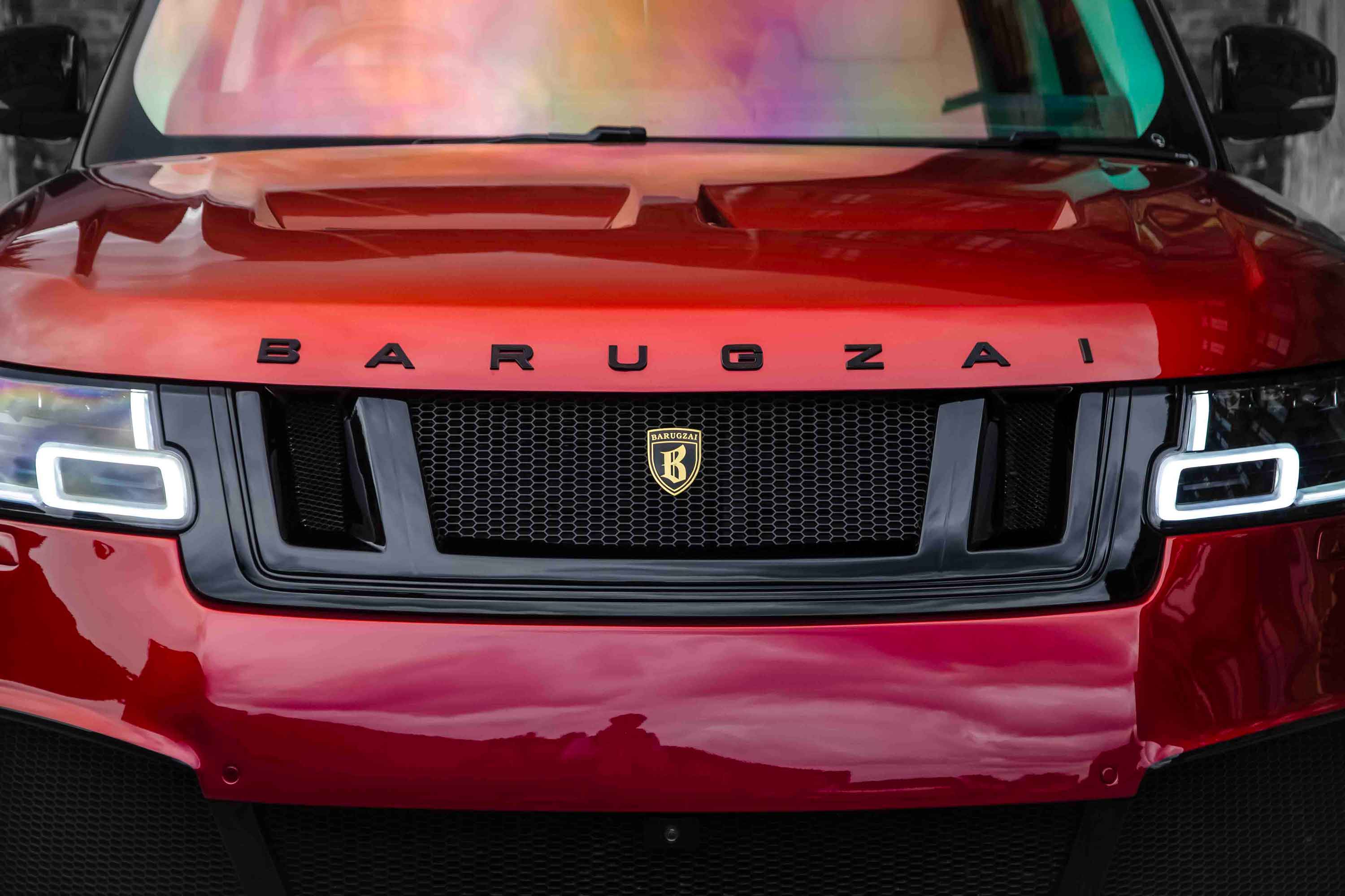 Red Range Rover L405, fitted Barugzai Bison bodykit with 'Barugzai' branding on a muted background. Chameleon windscreen tint