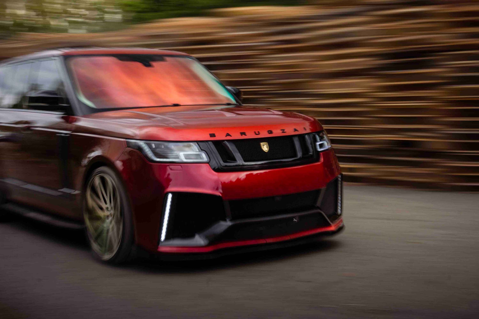 Red Range Rover L405, fitted with Barugzai Bison bodykit on a blurred background, motion blur movement