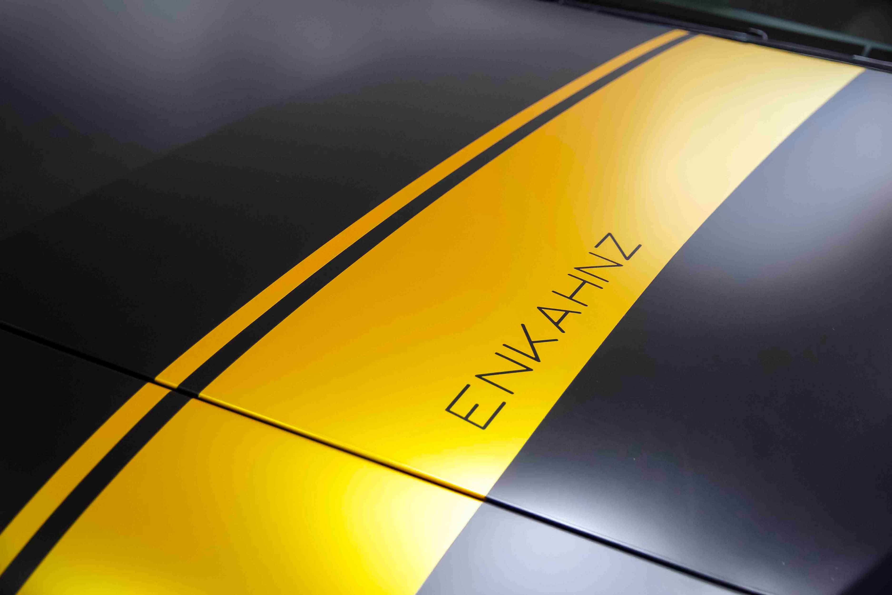 Close-up of a Mercedes A class bonnet with a yellow stripe and 'ENKAHNZ' branding, gun metal grey satin vinyl wrap 