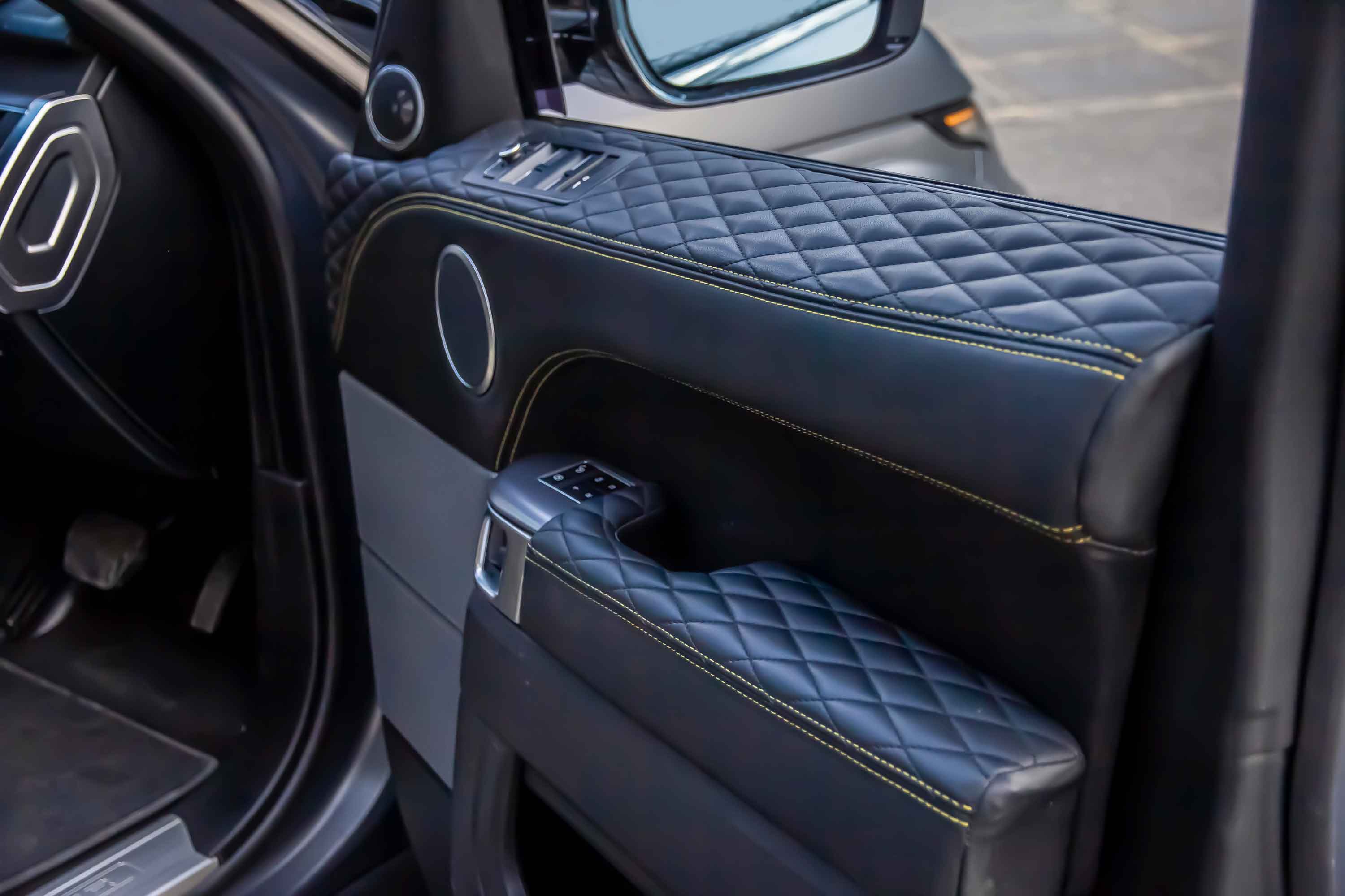 Close-up of a Range Rover Sport L494 interior door panel, door card with quilted design